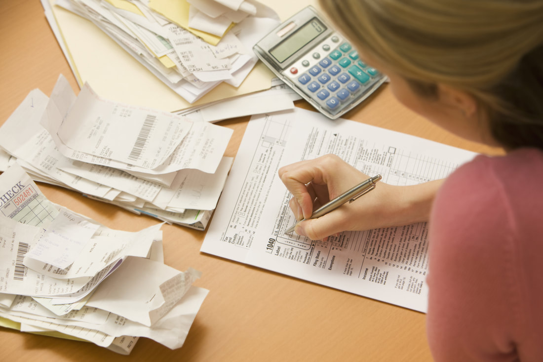 woman-filling-out-tax-form-14647065_orig woman-filling-out-tax-form-14647065_orig